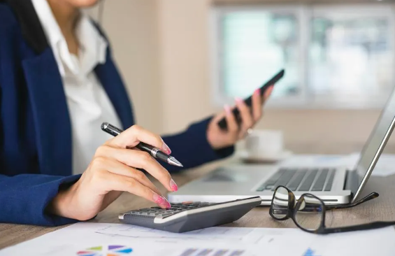 woman calculating fees at her desk